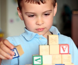 Autistic boy building with blocks